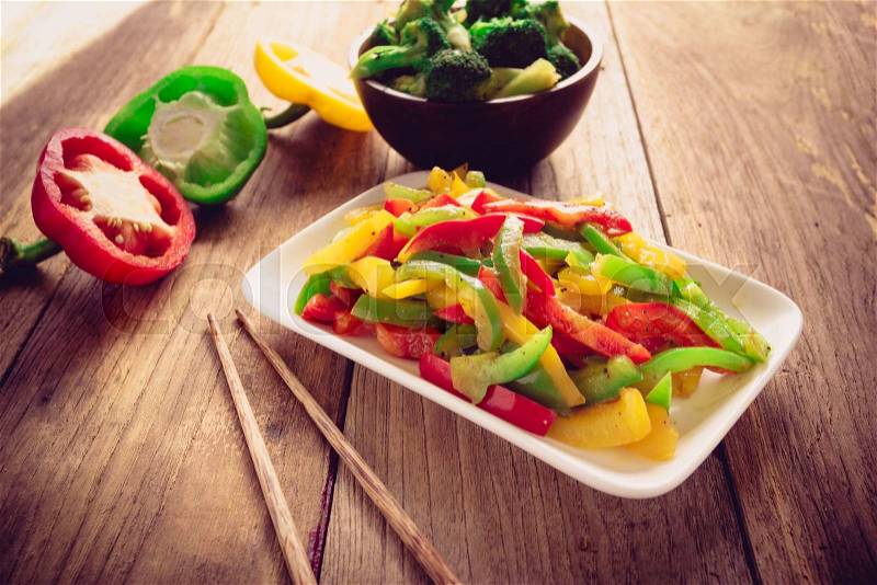 Stir fired mix color of sweet peppers on old wood, Vegetarian food , stock photo