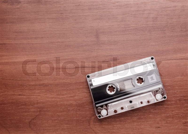 Audio cassette is lying on the wooden table, stock photo