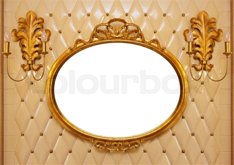 Luxury vintage mirror with gold frame on the wall. Isolated inside, stock photo