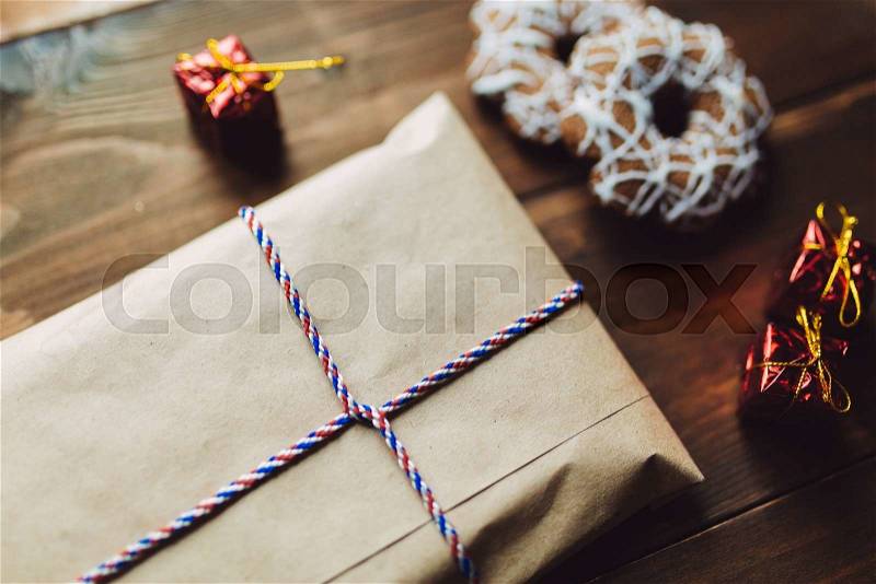 Craft envelope on the wooden table with New Year handmade toys and cookies, stock photo