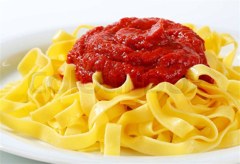 Thin ribbon pasta with tomato puree, stock photo