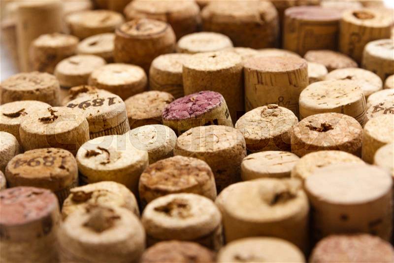 Closeup of a wall of used wine corks. A random selection of used wine corks, some with vintage years, stock photo