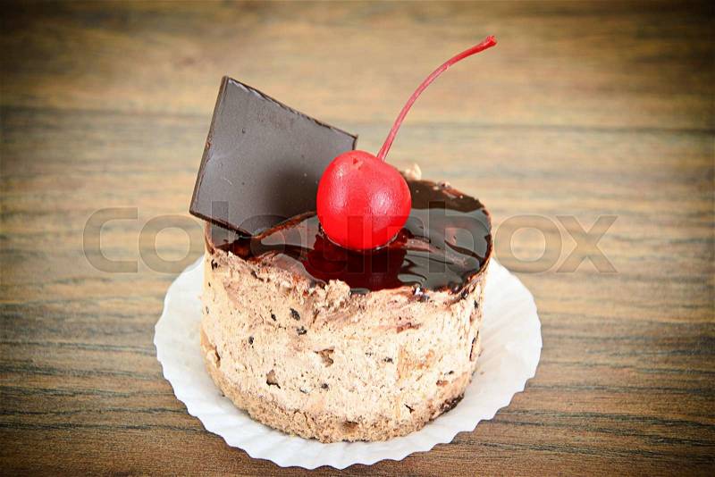 Cake with Cherries and Chocolate, Cupcake on Wood Background. Studio Photo, stock photo