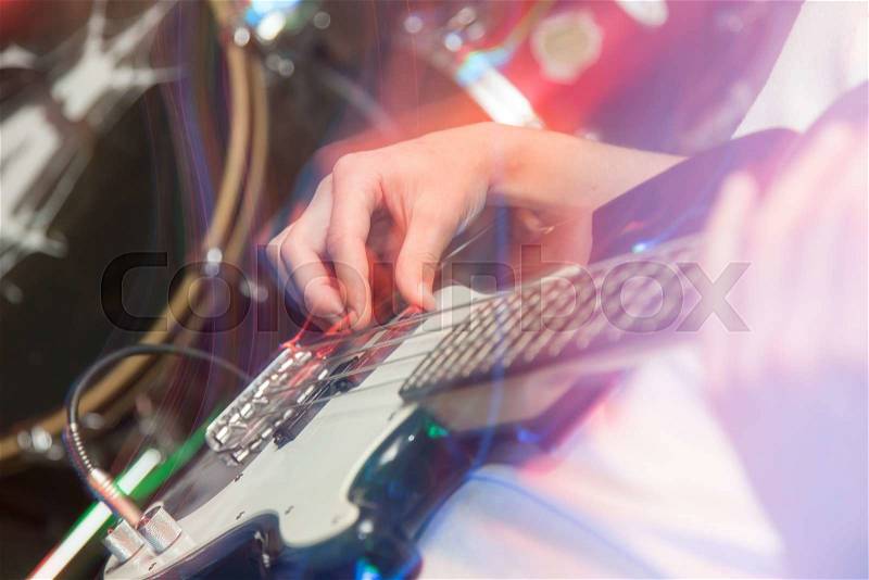 Aggressive play guitar on stage, stock photo