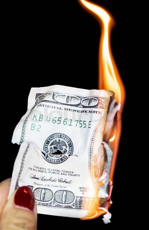 100 dollars burning on a black background, stock photo