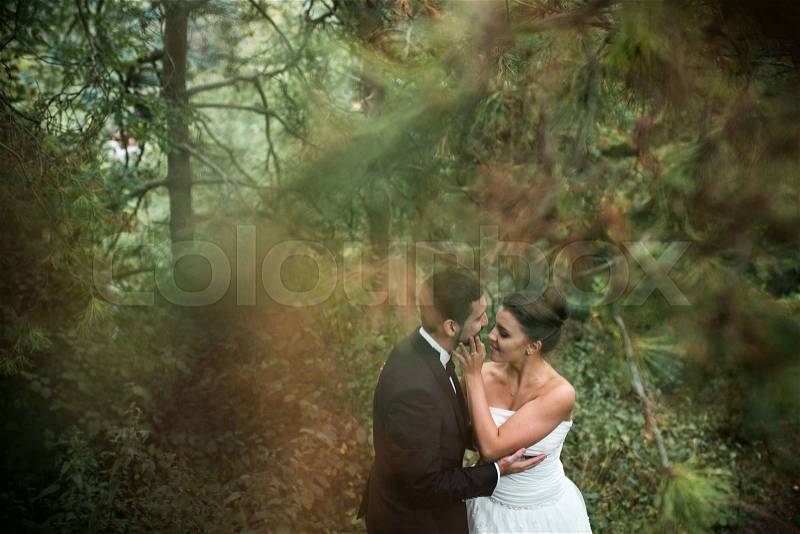 Bride and groom dancing the first dance together in the woods, stock photo