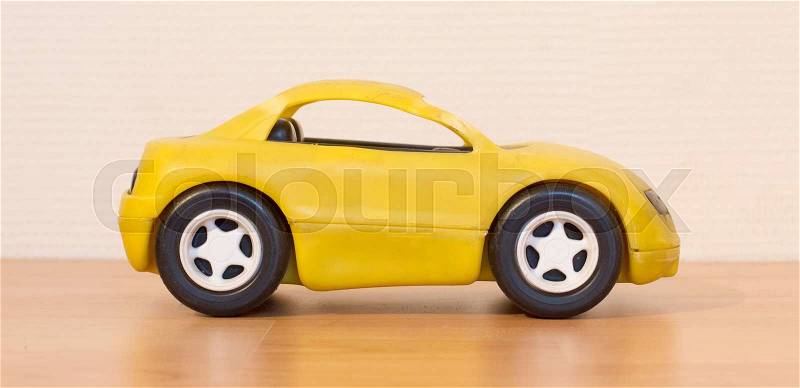 Clear colored small car toy, selective focus, stock photo