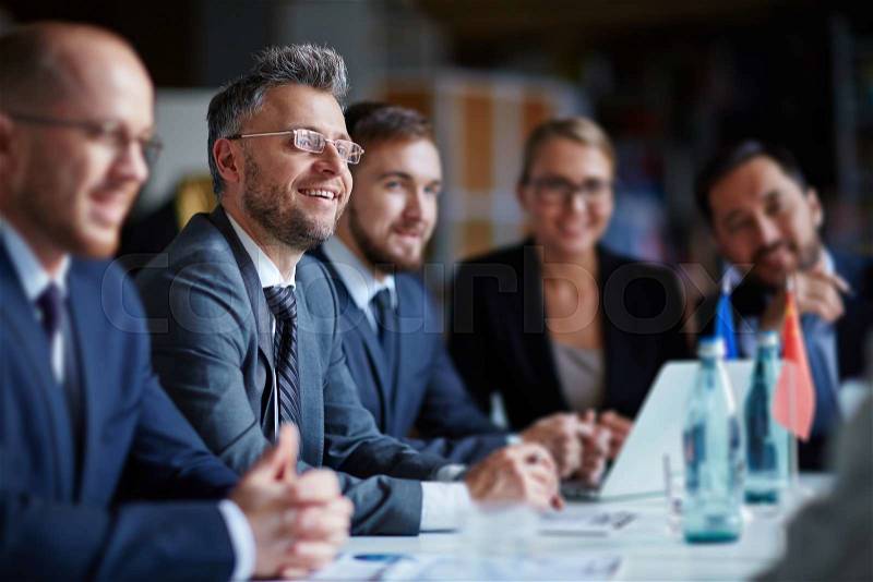 Successful businesspeople sitting at conference or seminar during lecture, stock photo