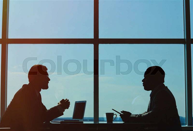 Outlines of two businessmen having meeting, stock photo