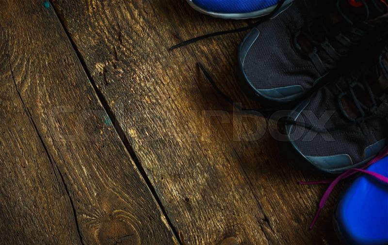 Sport, fitness, shoes, footwear concept - close up of sneakers on wooden background, stock photo