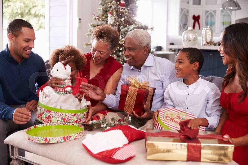 Family With Grandparents Opening Christmas Gifts, stock photo