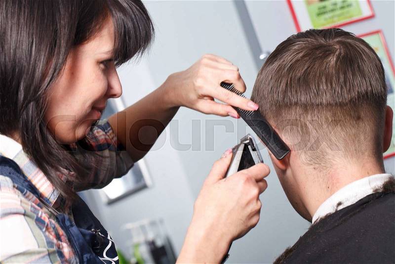 The master the hairdresser does a hairdress in salon, stock photo