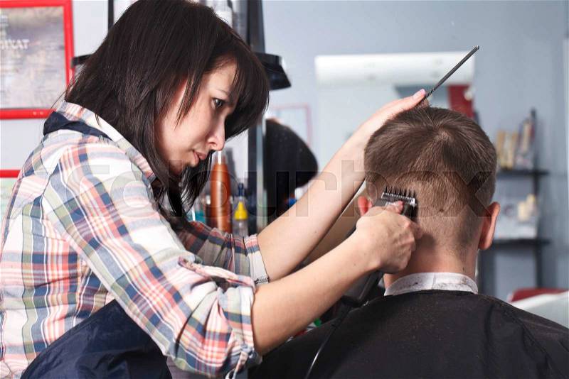 The master the hairdresser does a hairdress in salon, stock photo