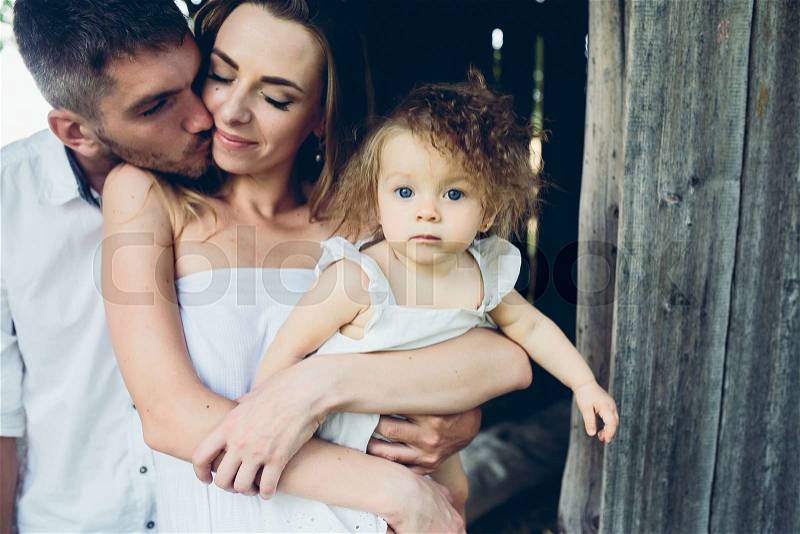 Mother, father and daughter together having fun on the farm, stock photo