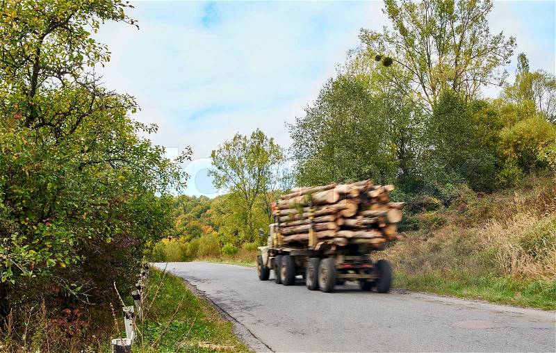 Logging truck timber lorry in motion blur, stock photo