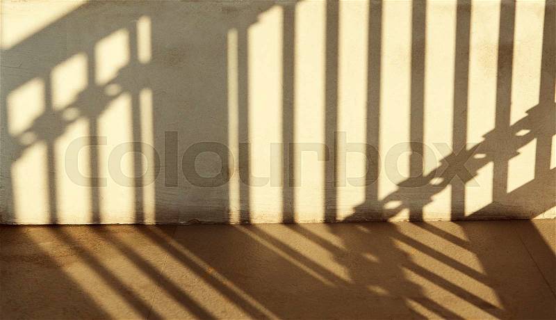 Warm light with shadows on wall, stock photo