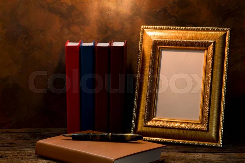 Still life of picture frame on table with diary book, stock photo