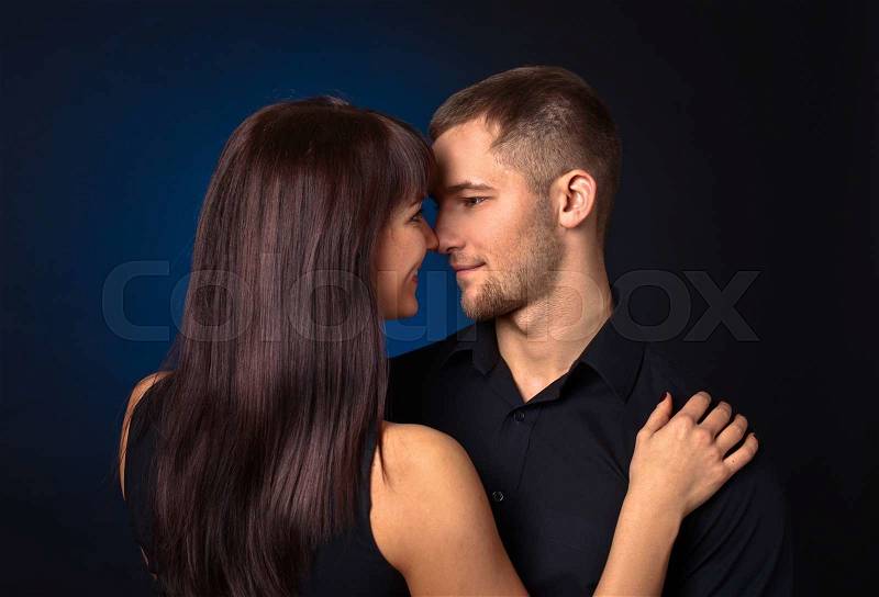 The couple in love on dark background, stock photo