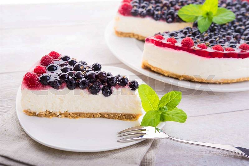 Tasty cake with fresh raspberries on wood table, stock photo