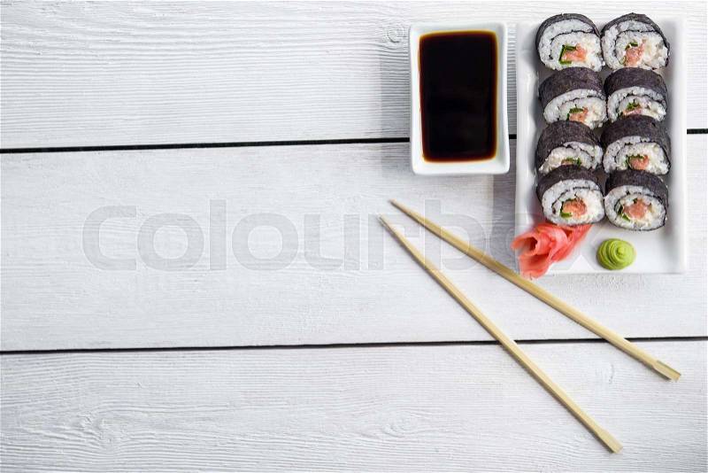 Sushi and roll with cream cheese and salmon fish inside. Top view, stock photo