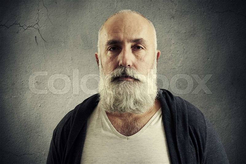 Portrait of stylish senior man with grey-haired beard over grey background, stock photo