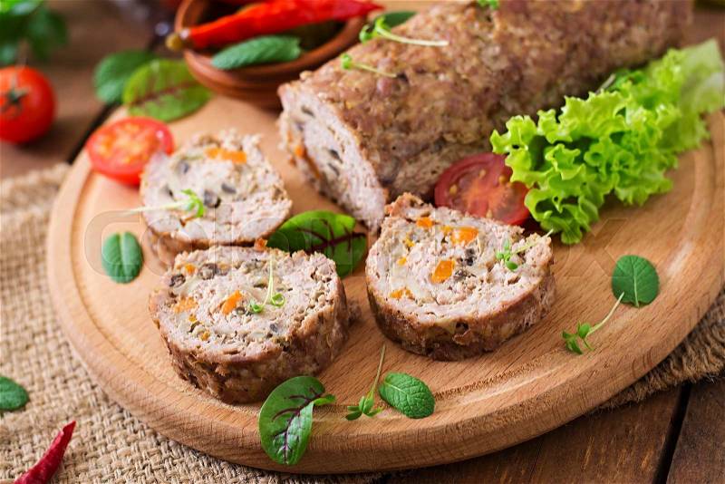 Minced meat loaf roll with mushrooms and carrots, stock photo
