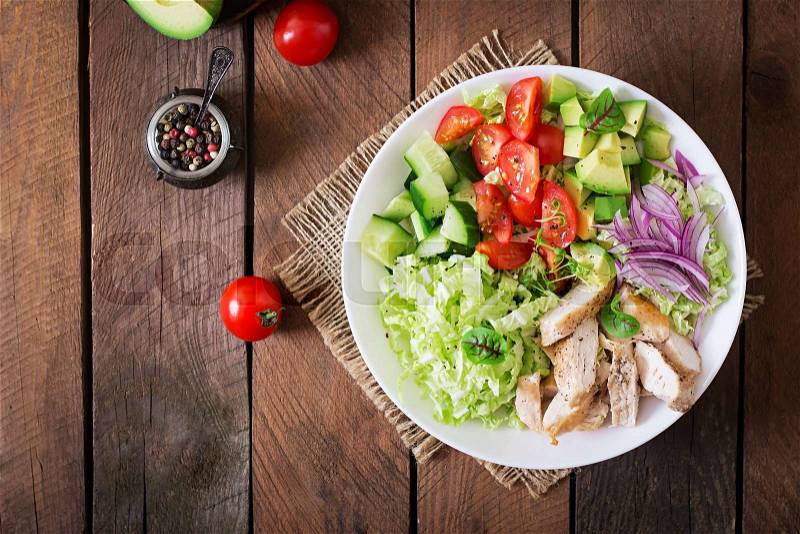Dietary salad with chicken, avocado, cucumber, tomato and Chinese cabbage. Top view, stock photo
