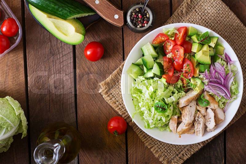 Dietary salad with chicken, avocado, cucumber, tomato and Chinese cabbage. Top view, stock photo