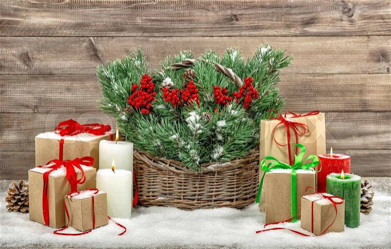 Christmas decoration with burning candles and gift boxes. Vintage style still life, stock photo