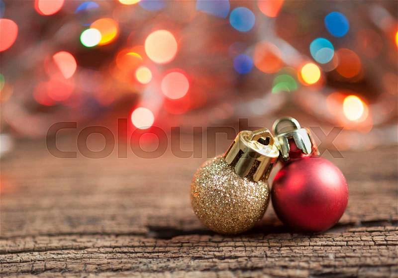 Christmas balls and colored Christmas lights on wooden table, selective focus, stock photo