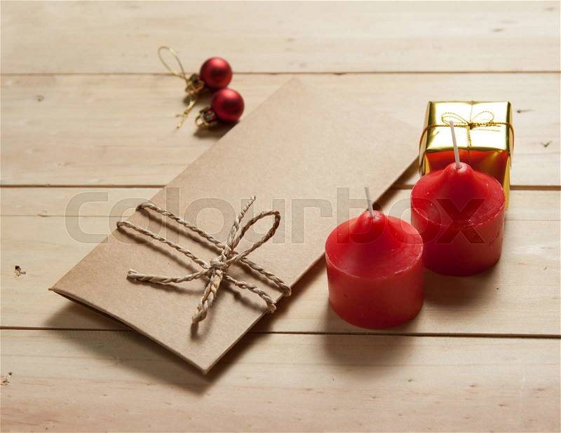 Envelope paper with candle and color ball on wood background,christmas holiday background, stock photo