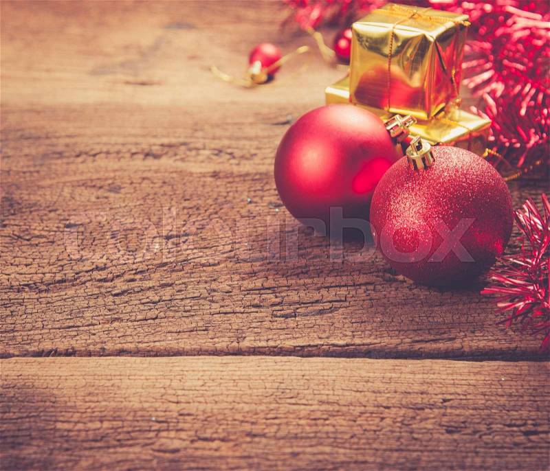 Christmas gift box with decorations and color ball on wood background,vintage color toned image, stock photo