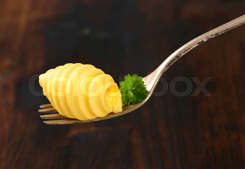 Butter curl on metal fork, stock photo