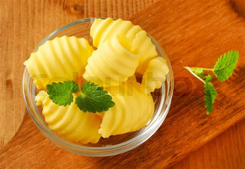 Curls of fresh butter in glass bowl, stock photo