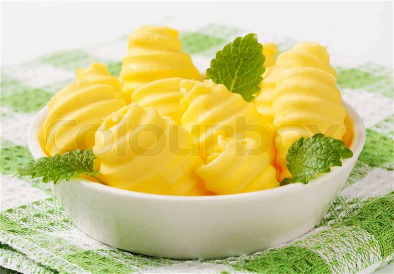 Curls of fresh butter in glass bowl, stock photo