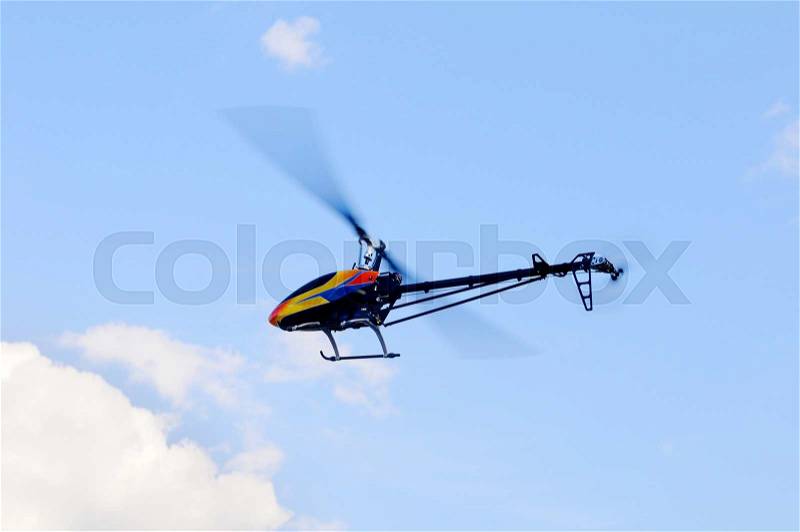 Flying remote controlled helicopter, stock photo