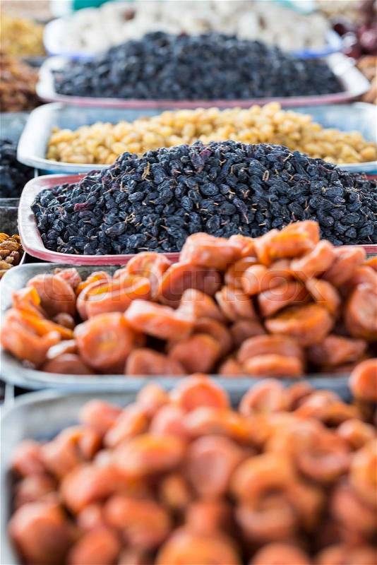 Dry fruits and spices like cashews, raisins, cloves, anise, etc. on display for sale in a bazaar in Osh Kyrgyzstan, stock photo