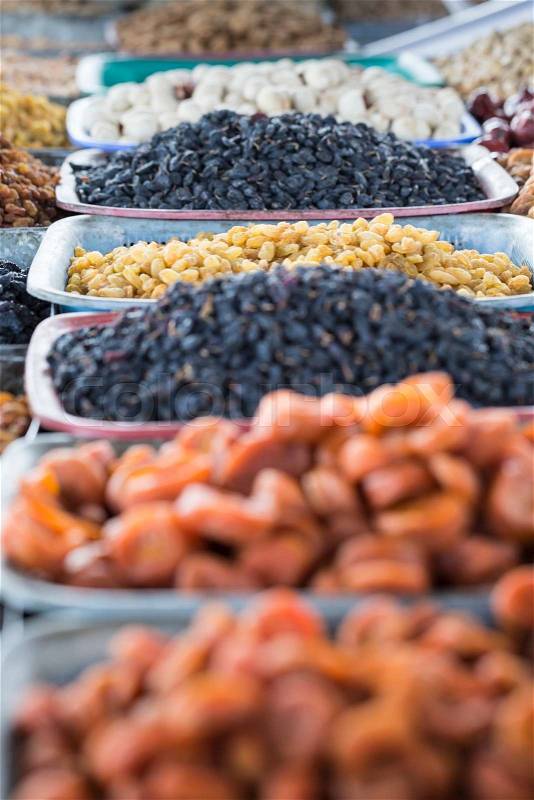 Dry fruits and spices like cashews, raisins, cloves, anise, etc. on display for sale in a bazaar in Osh Kyrgyzstan, stock photo