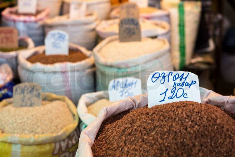 Spices and vegetables in bags at local bazaar in Osh. Kyrgyzstan, stock photo