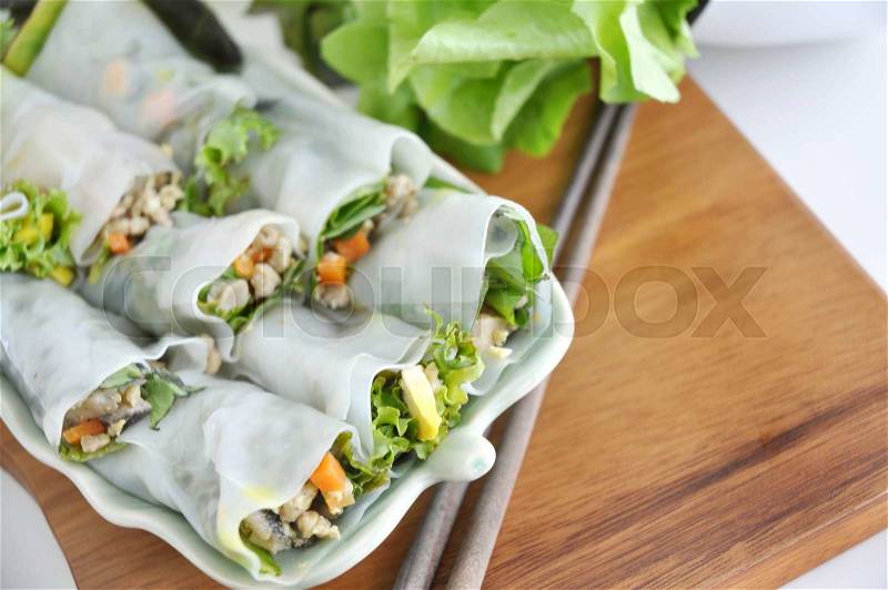 Top view of veggie and pork rolls on dish, stock photo