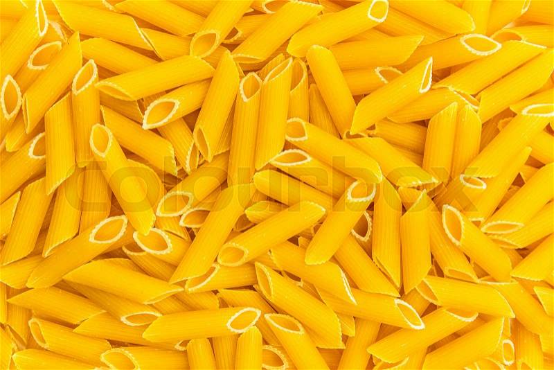 A background texture of penne integral noodles. Taken in Studio with a 5D mark III, stock photo