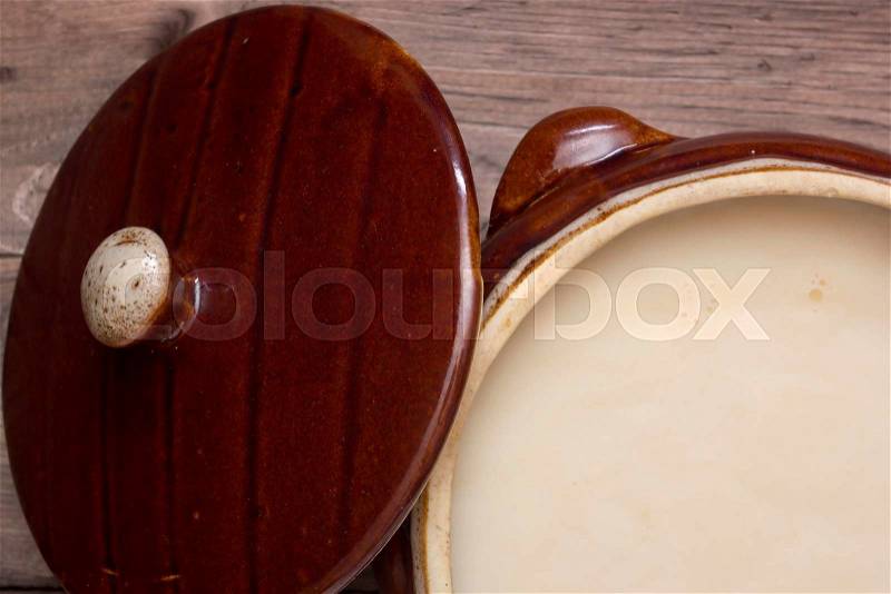Ceramic bowl with a lid, a bowl filled with melted pork lard, stock photo