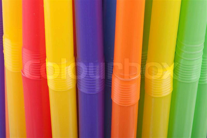 Plastic tubes of different colors in the background, stock photo