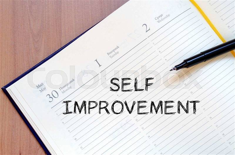 Self improvement text concept write on notebook with pen, stock photo