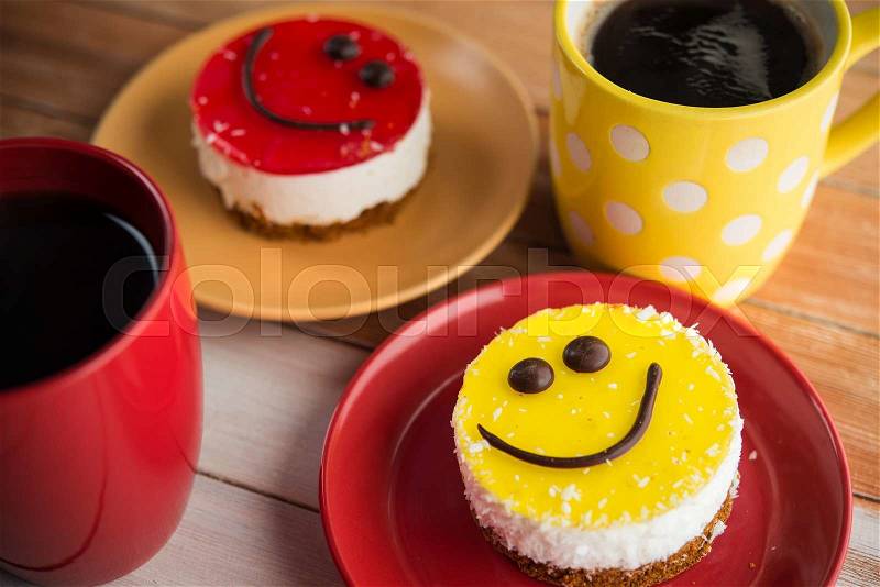 Coffee red cup and smile cake on wood table. Morning tasty breakfast, stock photo