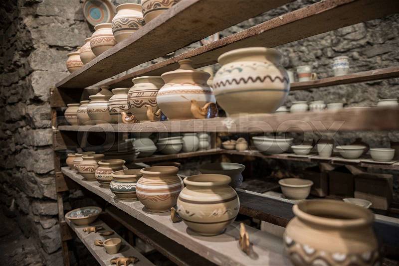 Shelves with Ukrainian ceramics in potter workshop, stock photo