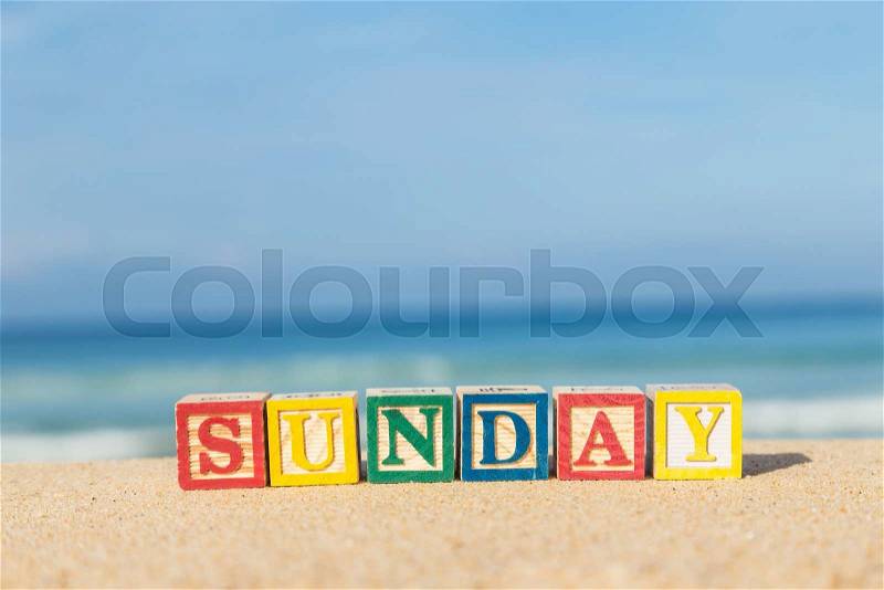 Word SUNDAY in colorful alphabet blocks on tropical beach, Phuket Thailand, stock photo