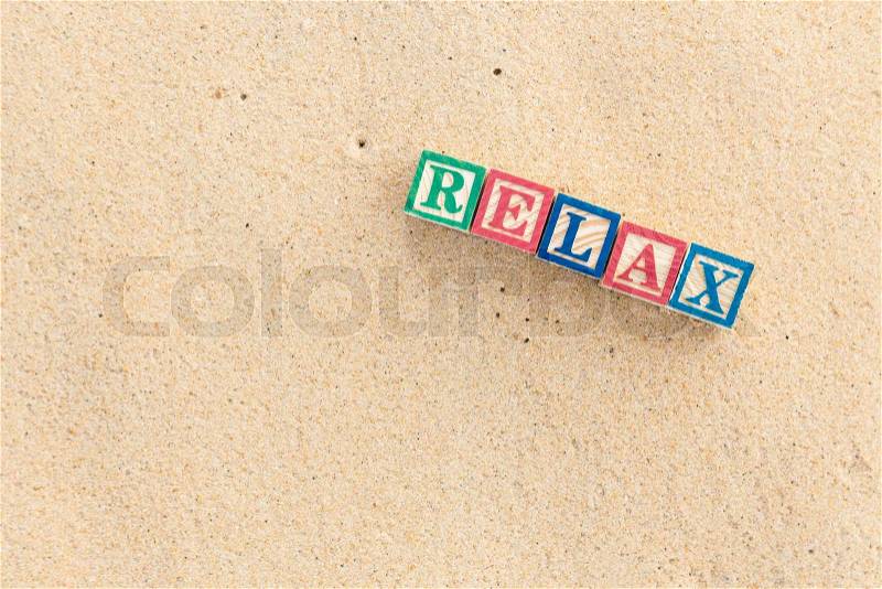 Word RELAX in colorful alphabet blocks on tropical beach, Phuket Thailand, stock photo