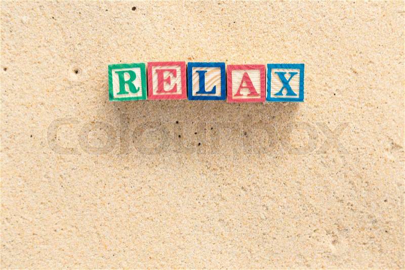 Word RELAX in colorful alphabet blocks on tropical beach, Phuket Thailand, stock photo