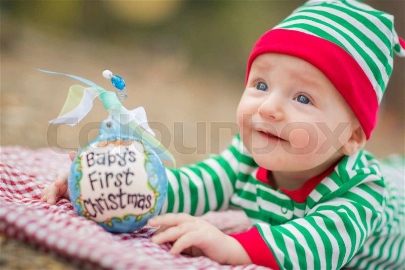 Beautiful Infant Baby On Blanket With Babys First Christmas Ornament, stock photo